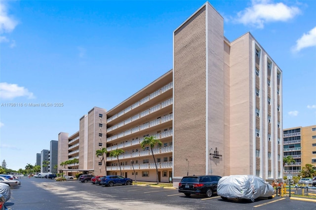 view of apartment building / complex featuring uncovered parking