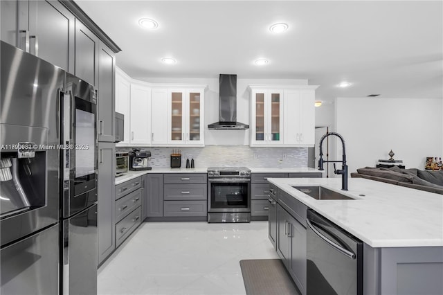 3372 SW 179th Ave, Miramar, FL 33029 - kitchen with stainless steel appliances, wall chimney range hood, gray cabinets, a sink, and backsplash