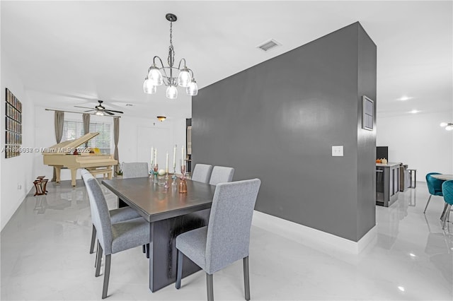 3372 SW 179th Ave, Miramar, FL 33029 - dining area featuring a chandelier, a ceiling fan, light marble finish flooring, and baseboards