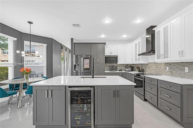 3372 SW 179th Ave, Miramar, FL 33029 - kitchen with stainless steel appliances, gray cabinetry, wine cooler, wall chimney range hood, and a sink