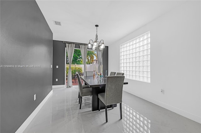 3372 SW 179th Ave, Miramar, FL 33029 - dining space featuring baseboards, a chandelier, and light marble finish floors