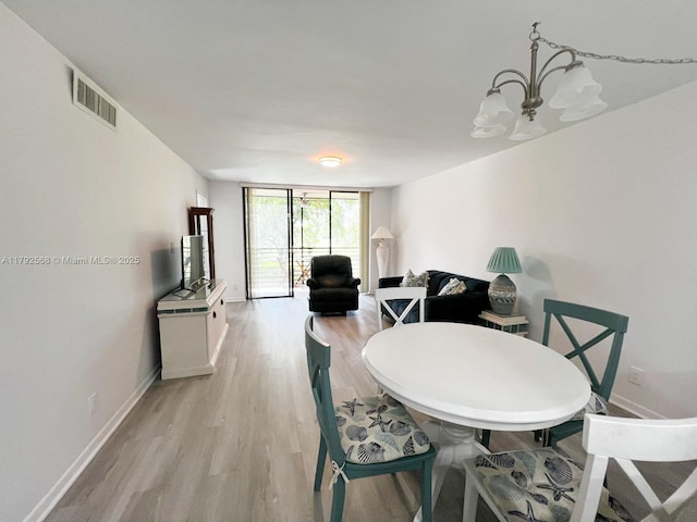 7950 W Mcnab Rd Unit 222, Tamarac, FL 33321 - dining room with light wood finished floors, baseboards, and a chandelier