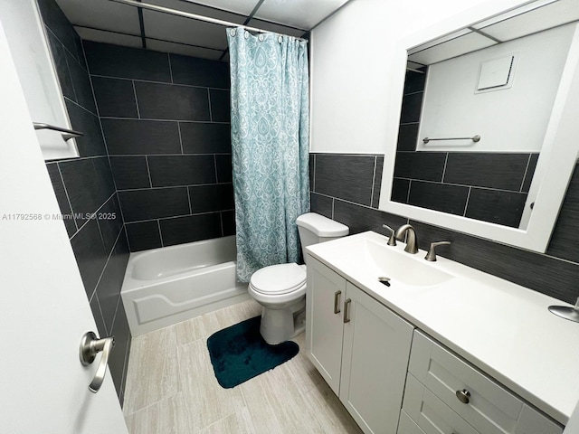 7950 W Mcnab Rd Unit 222, Tamarac, FL 33321 - bathroom featuring vanity, tile walls, shower / bath combo, toilet, and wainscoting