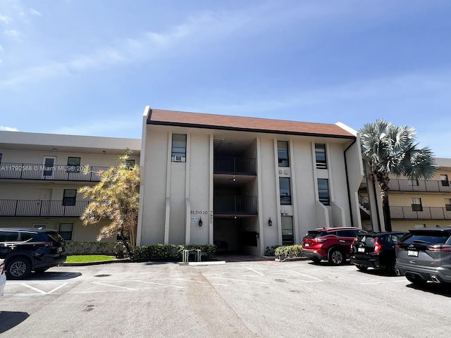 7950 W Mcnab Rd Unit 222, Tamarac, FL 33321 - view of building exterior featuring uncovered parking
