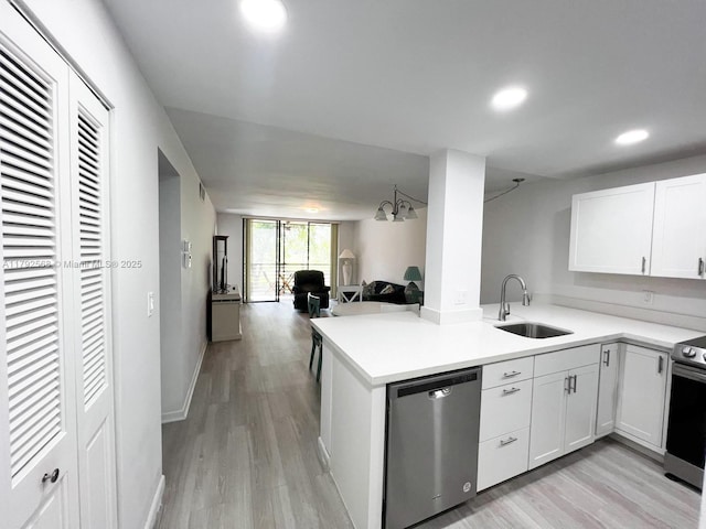 7950 W Mcnab Rd Unit 222, Tamarac, FL 33321 - kitchen with stainless steel appliances, a sink, open floor plan, light wood-type flooring, and recessed lighting