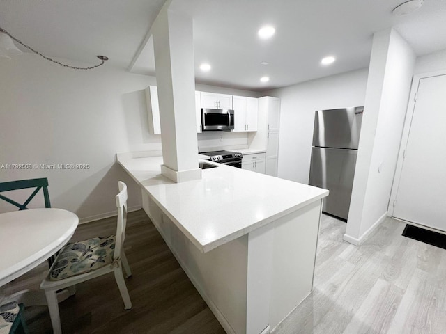 7950 W Mcnab Rd Unit 222, Tamarac, FL 33321 - kitchen with stainless steel appliances, light wood finished floors, light countertops, recessed lighting, and baseboards