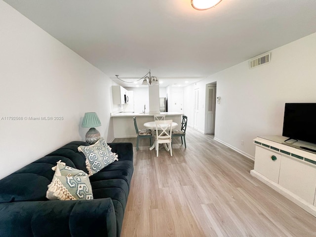 7950 W Mcnab Rd Unit 222, Tamarac, FL 33321 - living room featuring light wood-style flooring and baseboards