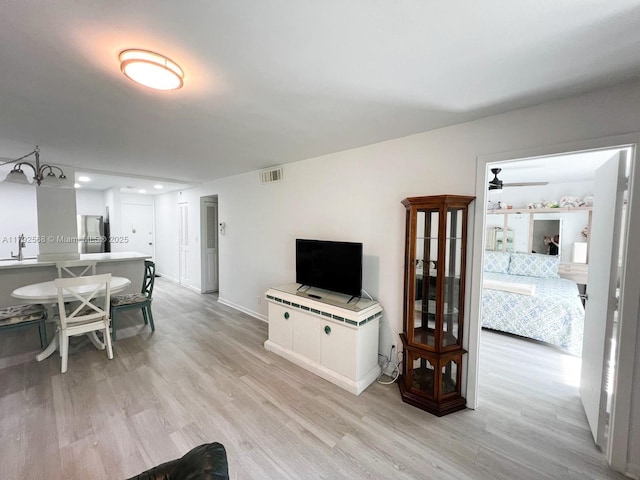 7950 W Mcnab Rd Unit 222, Tamarac, FL 33321 - living area featuring light wood-style floors, baseboards, and a ceiling fan