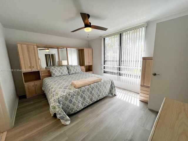7950 W Mcnab Rd Unit 222, Tamarac, FL 33321 - bedroom with wood finished floors, access to outside, and a ceiling fan