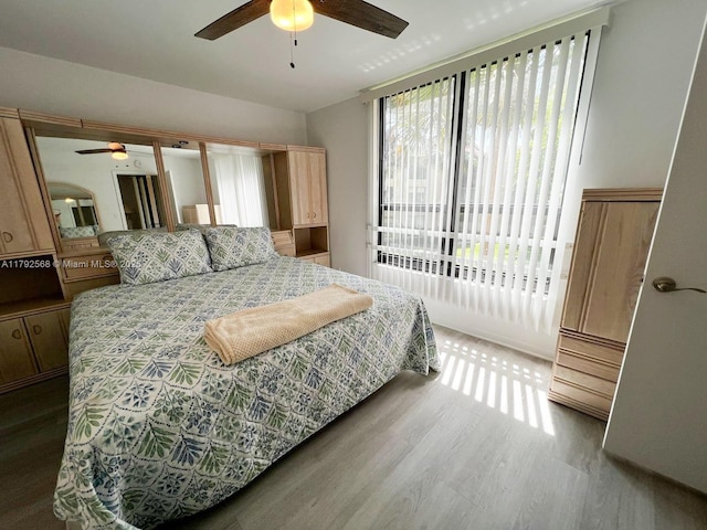 7950 W Mcnab Rd Unit 222, Tamarac, FL 33321 - bedroom featuring wood finished floors, access to exterior, and ceiling fan
