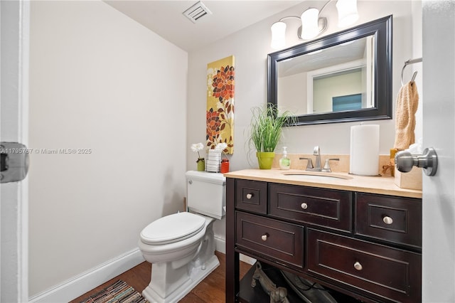 1470 NE 125th Ter Unit Ph9, North Miami, FL 33161 - bathroom featuring wood finished floors, toilet, vanity, and baseboards