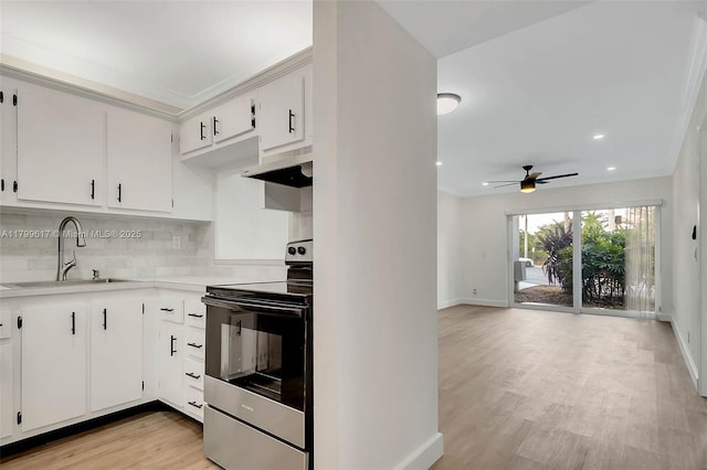8000 SW 81st Dr Unit 103, Miami, FL 33143 - kitchen with range with electric stovetop, a sink, under cabinet range hood, ceiling fan, and baseboards
