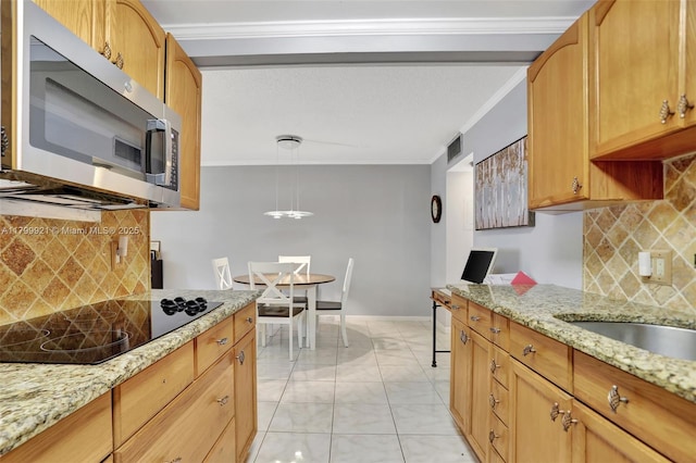 2405 Antigua Cir Unit E1, Coconut Creek, FL 33066 - kitchen featuring stainless steel microwave, black electric stovetop, crown molding, light marble finish flooring, and backsplash
