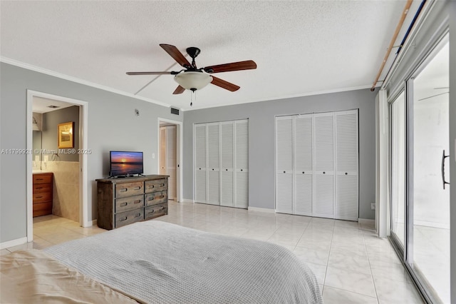 2405 Antigua Cir Unit E1, Coconut Creek, FL 33066 - bedroom with ornamental molding, two closets, a ceiling fan, ensuite bathroom, and a textured ceiling