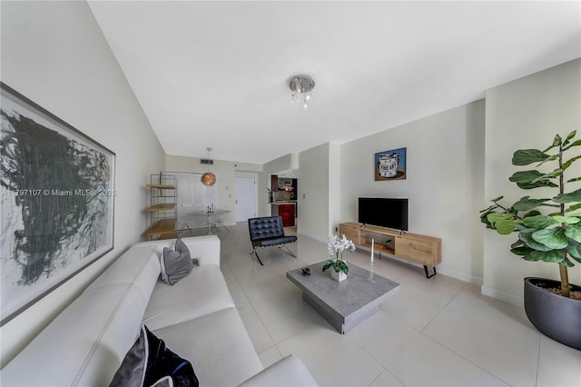 living area with light tile patterned flooring and baseboards
