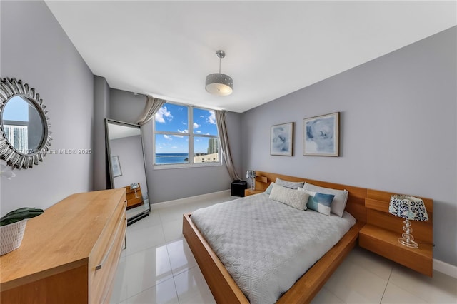 bedroom featuring light tile patterned flooring and baseboards