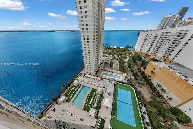 view of urban area featuring a pool area and a large body of water