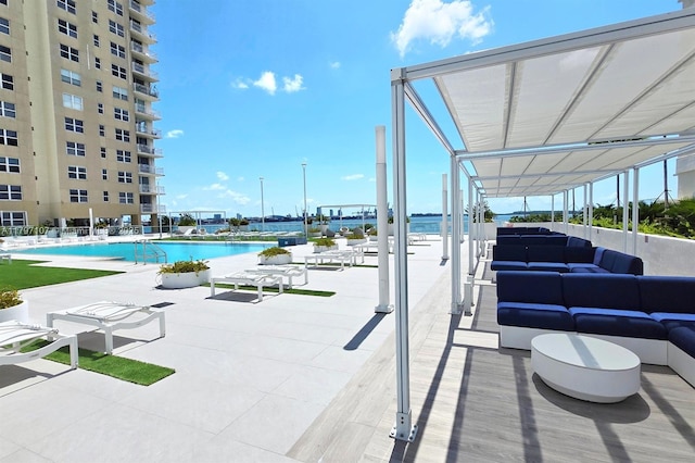 community pool with outdoor lounge area and a patio