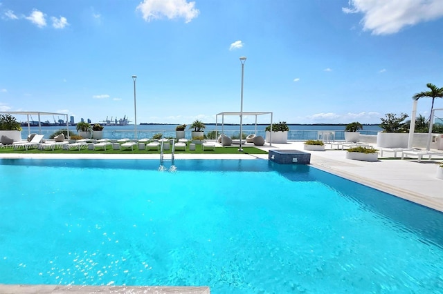 view of swimming pool featuring fence, a patio, and a pool with connected hot tub
