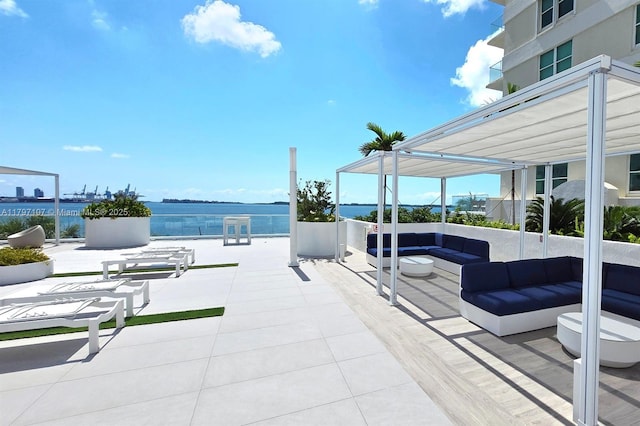 view of patio featuring an outdoor living space and a water view
