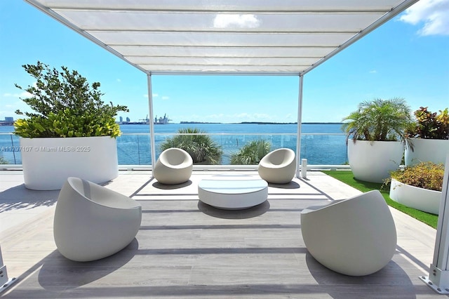 view of patio with a pergola and a water view
