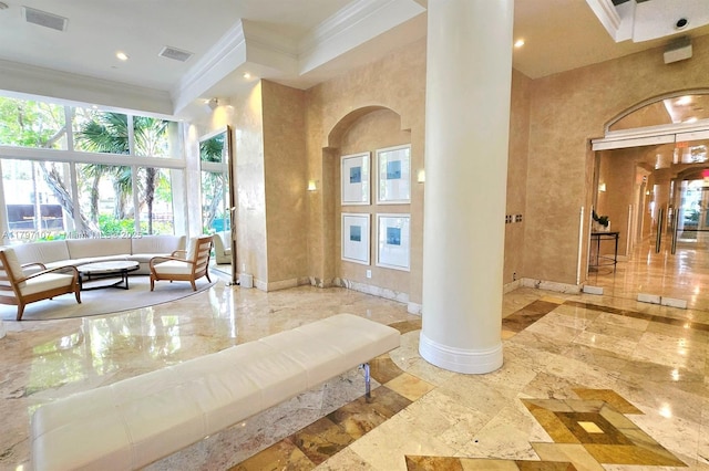 community lobby featuring crown molding, a high ceiling, and recessed lighting