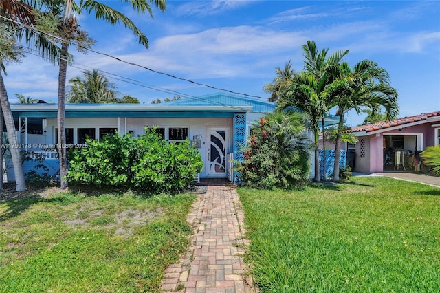 1155 Hayes St, Hollywood, FL 33019 - view of front facade with a front yard