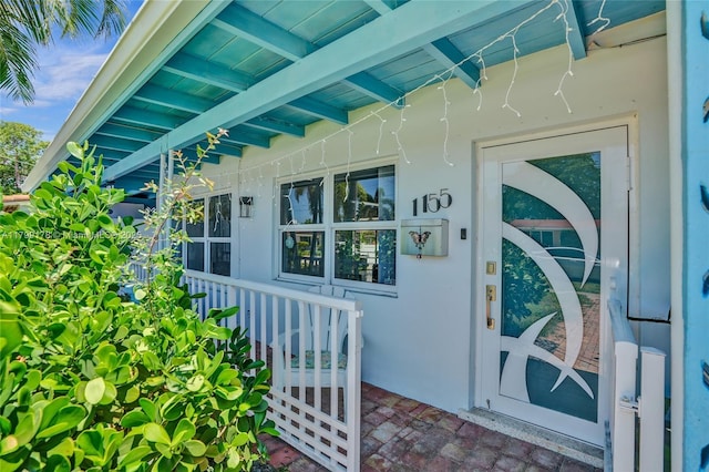 1155 Hayes St, Hollywood, FL 33019 - doorway to property with covered porch and stucco siding