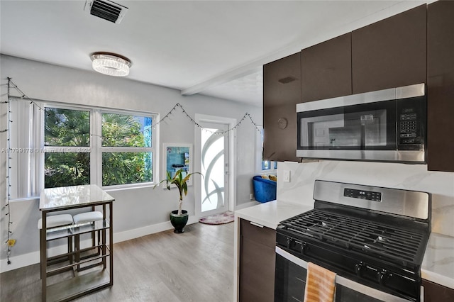 1155 Hayes St, Hollywood, FL 33019 - kitchen with stainless steel appliances, light countertops, light wood-type flooring, and baseboards