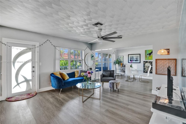 1155 Hayes St, Hollywood, FL 33019 - living room featuring wood finished floors, baseboards, ceiling fan, and a textured ceiling