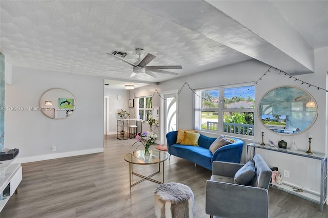 1155 Hayes St, Hollywood, FL 33019 - living area featuring ceiling fan, wood finished floors, baseboards, and a textured ceiling