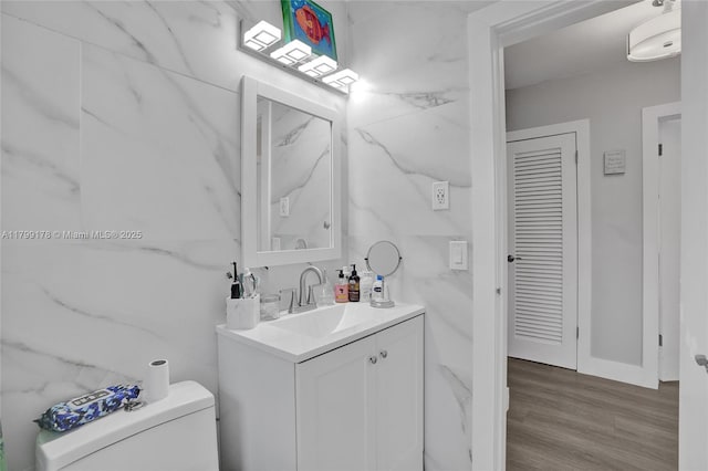 1155 Hayes St, Hollywood, FL 33019 - half bathroom with vanity, toilet, wood finished floors, and baseboards