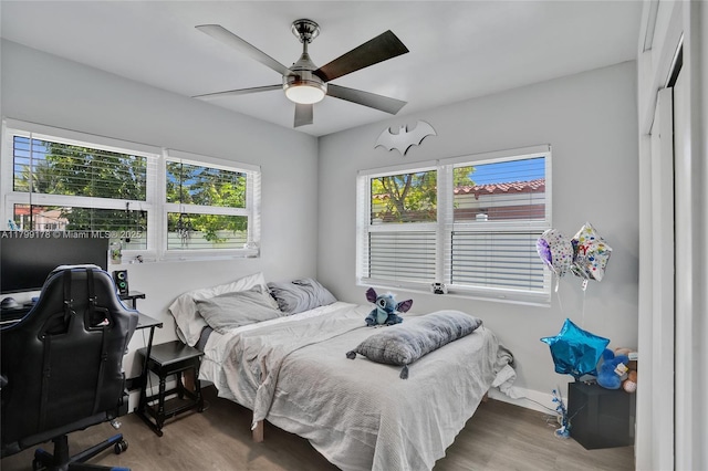 1155 Hayes St, Hollywood, FL 33019 - bedroom with multiple windows, wood finished floors, ceiling fan, and baseboards