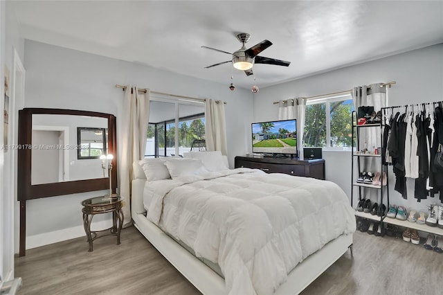 1155 Hayes St, Hollywood, FL 33019 - bedroom featuring multiple windows, wood finished floors, baseboards, and a ceiling fan