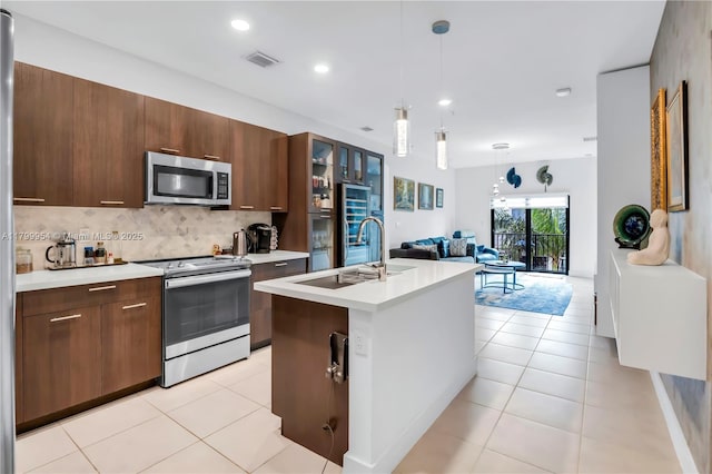 8301 NW 41st St Unit B-305, Doral, FL 33166 - kitchen with appliances with stainless steel finishes, a sink, light countertops, backsplash, and open floor plan