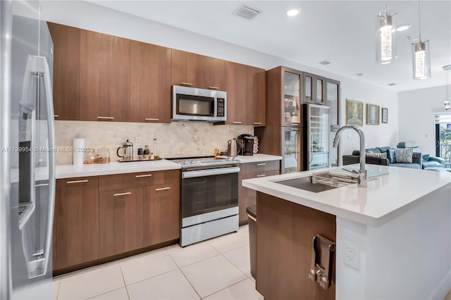 8301 NW 41st St Unit B-305, Doral, FL 33166 - kitchen with appliances with stainless steel finishes, light countertops, a sink, and tasteful backsplash
