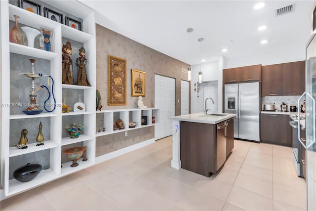 8301 NW 41st St Unit B-305, Doral, FL 33166 - kitchen with a sink, stainless steel appliances, light countertops, a kitchen island with sink, and dark brown cabinetry