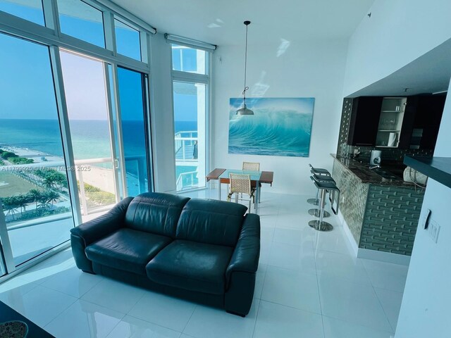 6515 Collins Ave Unit 1801, Miami Beach, FL 33141 - tiled living area featuring a water view