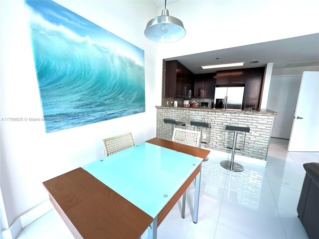 6515 Collins Ave Unit 1801, Miami Beach, FL 33141 - dining area with light tile patterned flooring