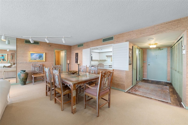 2450 Presidential Way Unit 1607, West Palm Beach, FL 33401 - dining space with light carpet, a textured ceiling, and rail lighting
