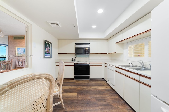 2450 Presidential Way Unit 1607, West Palm Beach, FL 33401 - kitchen featuring white appliances, a sink, light countertops, dark wood-type flooring, and white cabinetry