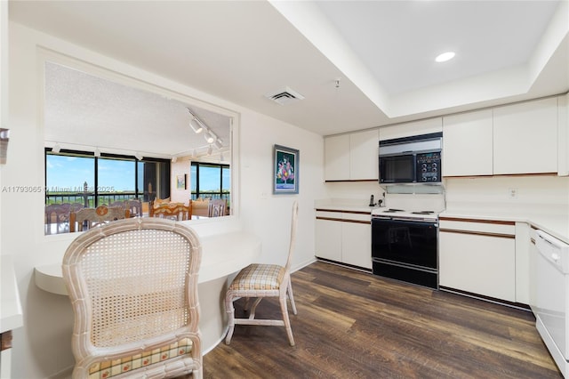 2450 Presidential Way Unit 1607, West Palm Beach, FL 33401 - kitchen featuring range with electric cooktop, black microwave, white cabinetry, and dark wood-style floors