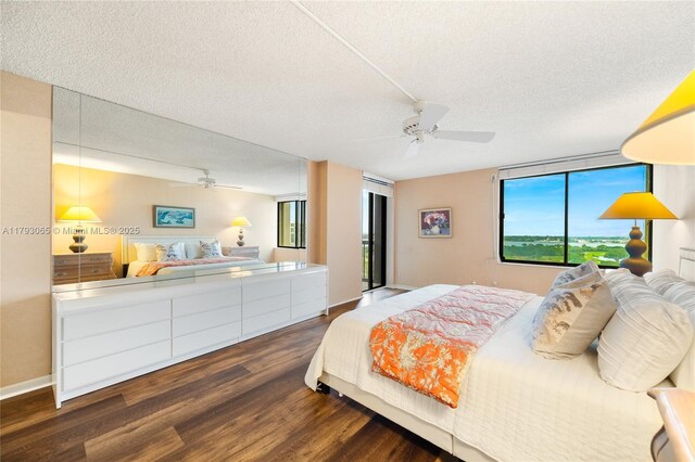 2450 Presidential Way Unit 1607, West Palm Beach, FL 33401 - bedroom with dark wood-style floors, a textured ceiling, a ceiling fan, and baseboards