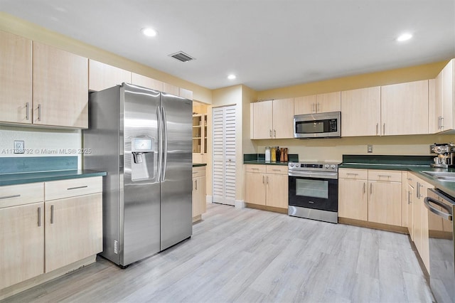 4161 W Silverado Cir, Davie, FL 33024 - kitchen with appliances with stainless steel finishes, light brown cabinets, dark countertops, light wood-type flooring, and recessed lighting