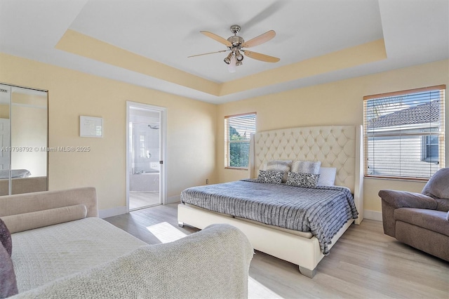 4161 W Silverado Cir, Davie, FL 33024 - bedroom featuring a raised ceiling, baseboards, light wood-type flooring, and ceiling fan