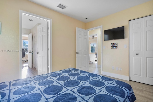 4161 W Silverado Cir, Davie, FL 33024 - bedroom with light wood-style flooring and multiple windows