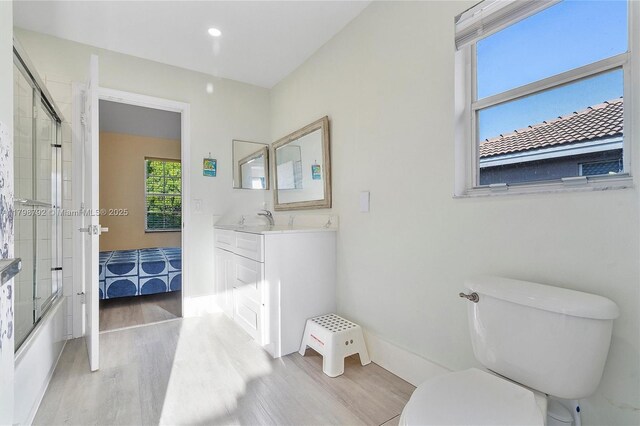 4161 W Silverado Cir, Davie, FL 33024 - bathroom with wood finished floors, toilet, shower / bath combination with glass door, vanity, and recessed lighting