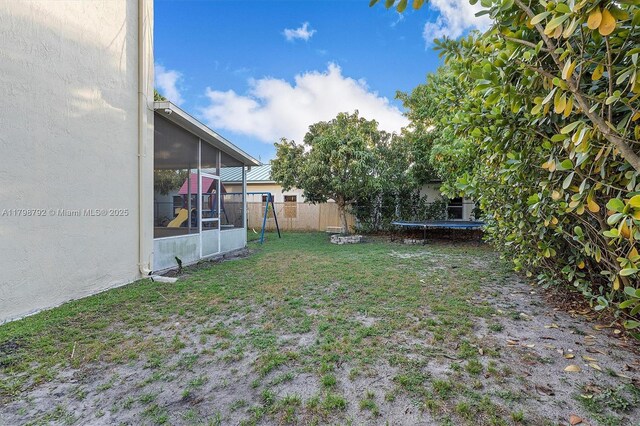4161 W Silverado Cir, Davie, FL 33024 - view of yard featuring a trampoline, a sunroom, and a playground