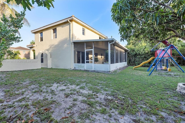 4161 W Silverado Cir, Davie, FL 33024 - back of house with a sunroom, stucco siding, a lawn, and a playground