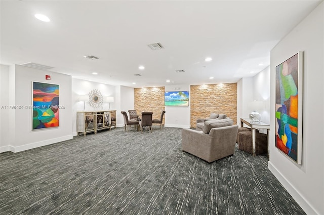 living area featuring baseboards and recessed lighting